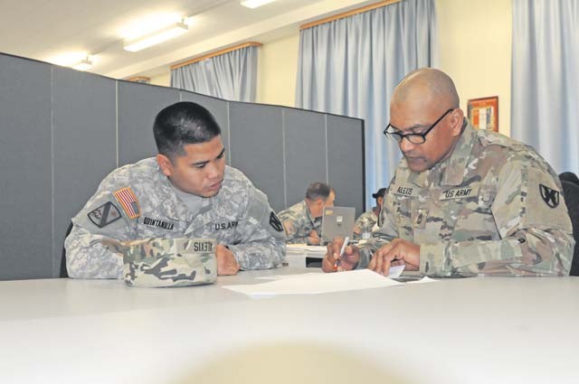 Sgt. Rodney Quintinilla and Sgt. 1st Class Ricardo Alexis of the 1st Human Resources Service Center discuss ongoing training during the unit’s Mission Readiness exercise Nov. 3.