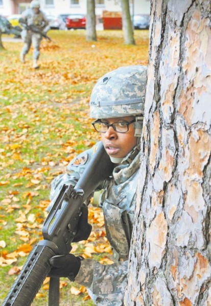 Spc. She-Ra Newell provides overwatch while her battle buddy (background) rushes for cover during basic Soldier tasks training that was part of the 1st Human Resources Service Center’s Mission Readiness exercise Nov. 3.