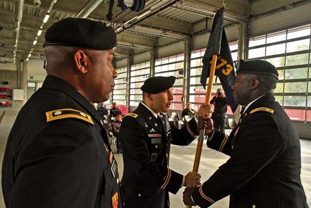 Col. Miguel Castellanos, commander of the 361st Civil Affairs Brigade (center), passes the 773rd Civil Support Team unit guidon to incoming commander Lt. Col. U.L. Armstrong during the 773rd change of command ceremony Oct. 30 in Halle, Belgium. Lt. Col. Sandy Sadler, outgoing 773rd commander (left), stands and watches.