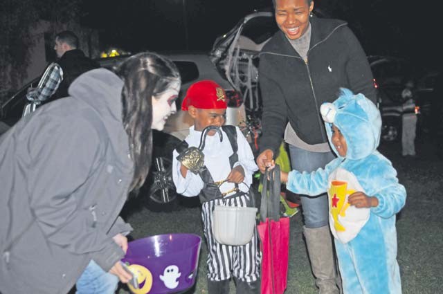 A young “pirate” and “care bear” (left) and “Dorothy” and “Toto” (right) search for candy and Halloween treats during “Trunk or Treat” festivities held the evening of Oct. 30 at NCO Field on Daenner Kaserne. Around 250 21st Theater Sustainment Command Soldiers, civilians and family members gathered for an evening of Halloween fun, food, revelry and, of course, trunk- or-treating. Soldier volunteers, many adorned in frightful Halloween attire, distributed treats from approximately 20 vehicles arrayed around the field. The annual event, conducted by the 21st Special Troops Battalion and 7th Mission Support Command on behalf of the entire TSC family, included “spooky” sights, sounds and tastes ranging from a haunted house and outdoor games to horror, monster and Halloween-themed music to brats and smores. Assisted by parents, TSC personnel and volunteers, young ghosts, goblins, witches, pirates, action heroes and even a handful of Millrinder pets trunk-or-treated, ran, chased and occasionally danced the frightfully festive night away.