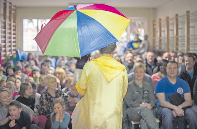 A student performs to "Singin' in the Rain" for U.S. and Polish airmen during a community outreach event Oct. 30 at a special needs school in Wrzesnia, Poland. The Airmen were deployed to Poland to participate in Aviation Detachment 16-1 where they worked to complete training requirements and build interoperability with the Polish air force. This marked the second visit to the school in a growing relationship with the local community.