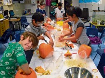 Photo by Mark Wilburn
Students in Sharon Emerling’s fifth-grade class at Landstuhl Elementary School carve pumpkins. The pumpkins had already been checked for volume and weight and were deemed suitable for carving. Left photo: Fifth grader Michael Toppings looks hungry as he carves his fall pumpkin. Right photo: Jordan Ankeney and her classmates dig in to create culinary masterpieces.