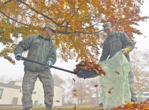 Staff Sgt. Tenzin Choegoyab and Airman 1st Class Ahmad Yehudah, both 86th Airlift Wing Command Post emergency action controllers, scoop up leaves during Base Pride Day Nov. 3 on Ramstein. Airmen and civilians around Ramstein were tasked to clean around their working areas during the biannual occasion. The two-day event gave base personnel time to beautify the base by picking up trash and raking leaves.