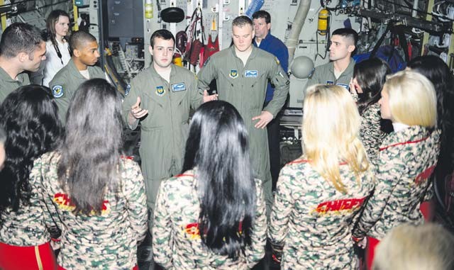 Airmen from the 37th Airlift Squadron explain their mission to the Kansas City Chiefs cheerleaders Nov. 2 on Ramstein. The base hosted the cheerleaders to explain how Ramstein supports and conducts the Air Force mission.