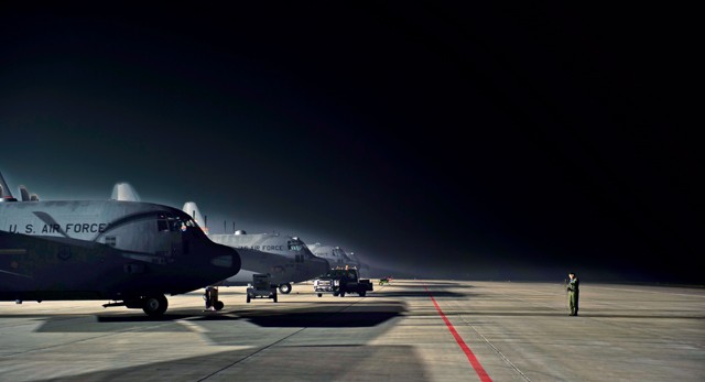 A 37th Airlift Squadron loadmaster prepares her communication equipment prior to takeoff Oct. 30 at Powidz Air Base, Poland. Loadmasters have a variety of responsibilities in the aircraft, including calculating the weight balance and rigging cargo for airdrops.
