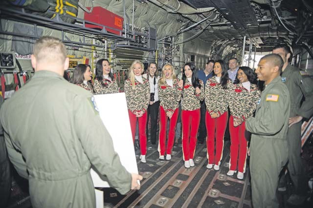 Airmen from the 37th Airlift Squadron share jokes with Kansas City Chiefs cheerleaders during a base tour Nov. 2 on Ramstein. The cheerleaders are slated to return to perform and provide a clinic for the families of the KMC.