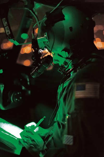 A C-130J Super Hercules pilot writes down coordinates of anti-aircraft “threats” as part of training during Aviation Detachment 16-1 Oct. 28 above Powidz, Poland. During the flying training deployment, pilots flew during the day and night to ensure mission capabilities were available in any situation.