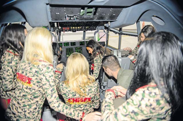 Airmen from the 86th Airlift Wing showcase one of their C-130J Super Hercules to the Kansas City Chiefs cheerleaders during a tour Nov. 2 on Ramstein.