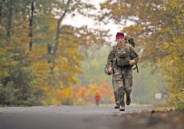 Airman 1st Class Kevin Leyden, 786th Civil Engineer Squadron explosive ordnance disposal technician, jogs along a trail during a ruck march Oct. 30 on Ramstein. The ruck march mirrored an EOD course where participants traversed three miles, climbed a six-foot wall and carried jerry cans for 50 meters all while wearing a 50-pound pack as part of the event. The course was held to help raise money for the 2015 Combined Federal Campaign-Overseas. The mission of the CFC-O is to support and promote philanthropy through a voluntary program that is employee-focused, cost-efficient and effective in providing all federal employees the opportunity to improve the quality of life for all.