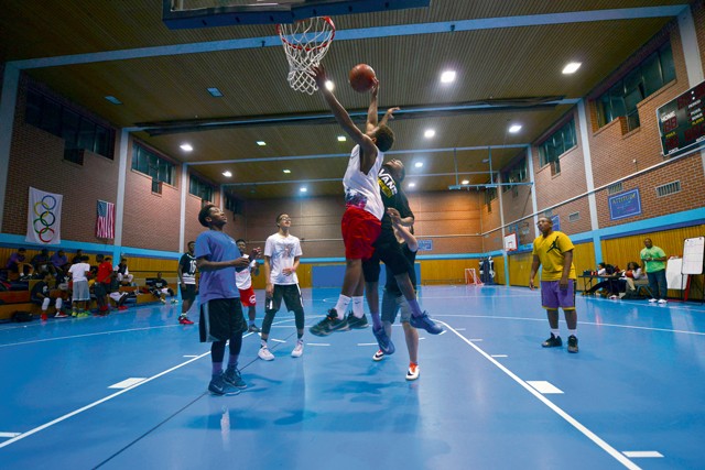 Participants in the Work Accountability Responsibility Respect Integrity Opportunity Represent Program play a basketball game Oct. 30 on Ramstein. The WARRIOR Program uses basketball as a tool to bring young men together and is a targeted effort to reinforce character, leadership and positive behavior.