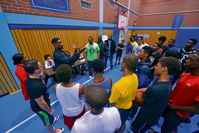 Participants in the Work Accountability Responsibility Respect Integrity Opportunity Represent Program listen to mentors from the local community during an operation night hoops event  Oct. 30 on Ramstein. The WARRIOR Program is open to males ages 13 to 18 and aims to engage young men in discussions unique to the challenges they face while progressing into manhood.