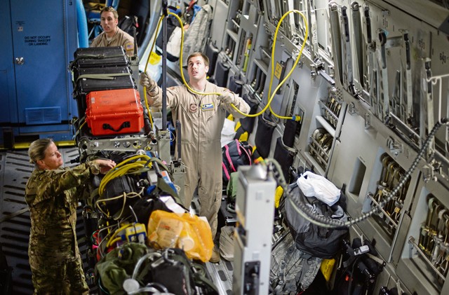 Tech. Sgt. Derek Matway, 10th Expeditionary Aeromedical Evacuation Squadron technician, sets up medical equipment inside a C-17 Globemaster III Nov. 10 on Ramstein. Matway and a crew of medical Airmen flew to a deployed location in Southwest Asia to retrieve service members in need of medical attention.