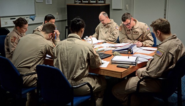 A crew from the 10th Expeditionary Aeromedical Evacuation Flight conducts a pre-mission briefing prior to an evacuation mission Nov. 10 on Ramstein. The crews conduct pre-mission briefings to discuss and understand flight plans, safety operations, necessary supplies, number of patients and their health conditions. 