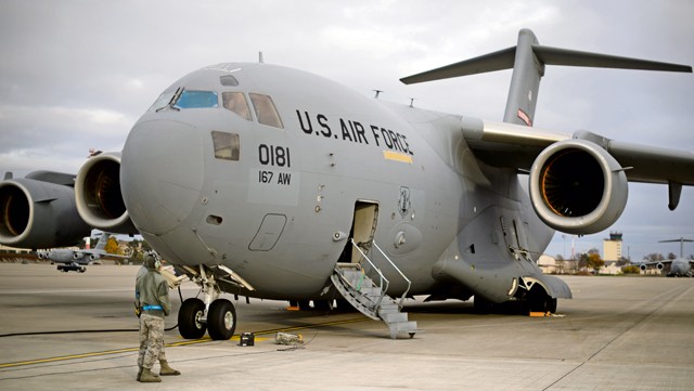 Crew chiefs from the 521st Air Mobility Operations Wing stand beside a C-17 Globemaster III prior to an aeromedical evacuation mission Nov. 10 on Ramstein. The 521st AMOW, including the 10th Expeditionary Aeromedical Evacuation Flight, conducts regular missions to the U.S. Central Command area of operation to return wounded warriors home.