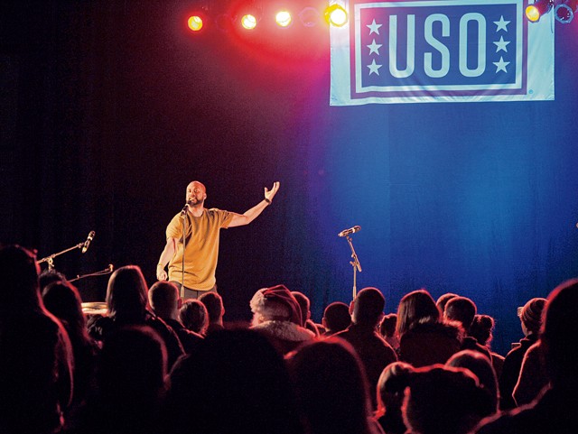 Photo by Staff Sgt. Timothy Moore Comedian Sydney Castillo performs during the 2015 USO Holiday Troop Tour Dec. 9 on Ramstein. Castillo and other celebrities joined U.S. Marine Corps Gen. Joseph F. Dunford Jr., chairman of the Joint Chiefs of Staff, for the 15th annual tour as a way to show thanks to service members and their families for their service.