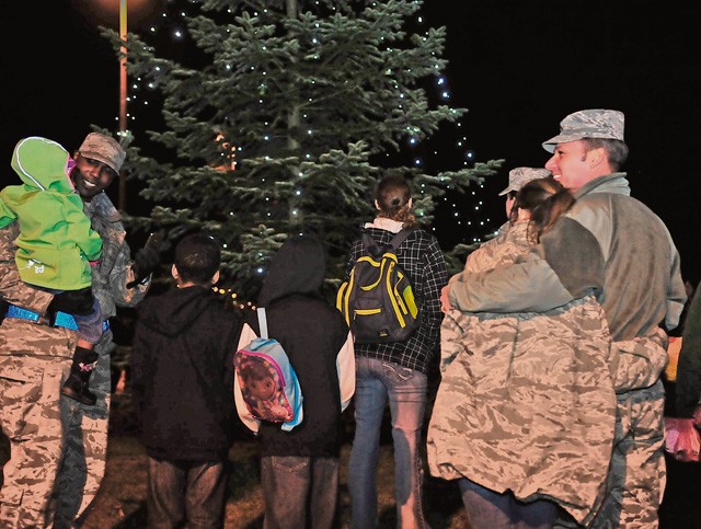 Families from the KMC gather around for a tree lighting ceremony Nov. 30 on Ramstein. The ceremony consisted of performances by the U.S. Air Forces in Europe Band, the Blackbirds Chamber Choir and the Ramstein Liturgical Service Bell Choir. Following the ceremony, attendees were invited to the Ramstein Officers' Club to visit with Santa Claus and enjoy cookies and hot cocoa.