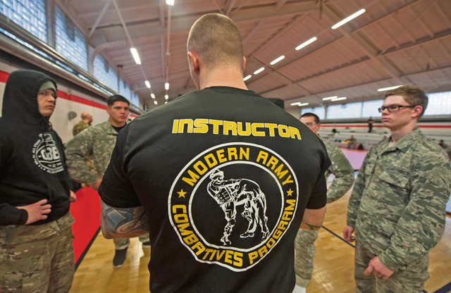 U.S. Army Sgt. 1st Class David Maybury, an Army combatives instructor, explains the rules of the competition to the top ranking fighters during the 7th Mission Support Command's Army Combatives Tournament Dec. 4 on Kleber Kaserne.
