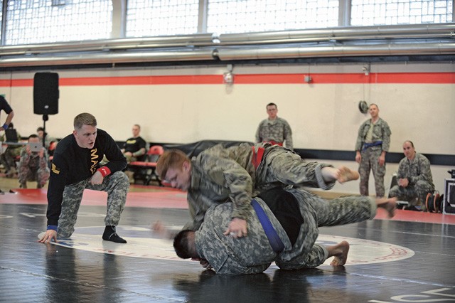 U.S. Air Force Staff Sgt. Joseph Everett (top), 86th Aircraft Maintenance Squadron, bouts with an Army soldier during the 7th Mission Support Command's Army Combatives Tournament Dec. 4 on Kleber Kaserne. 