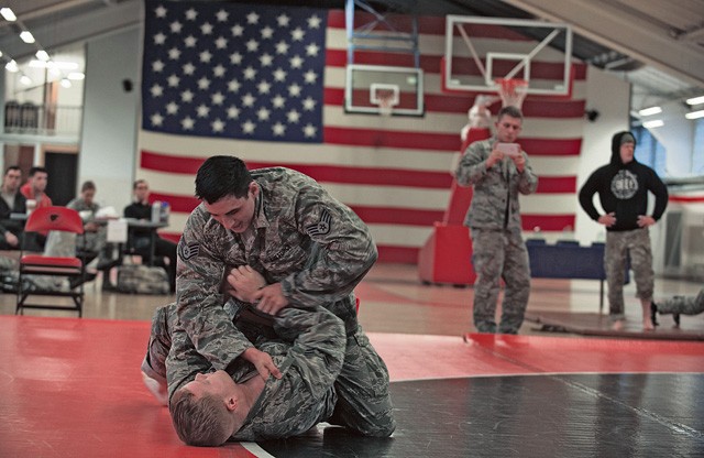 U.S. Air Force Staff Sgt. Anthony Qujada (top) bouts with Airman 1st Class Jonathon Douglas during the 7th Mission Support Command's Army Combatives Tournament Dec. 4 on Kleber Kaserne.