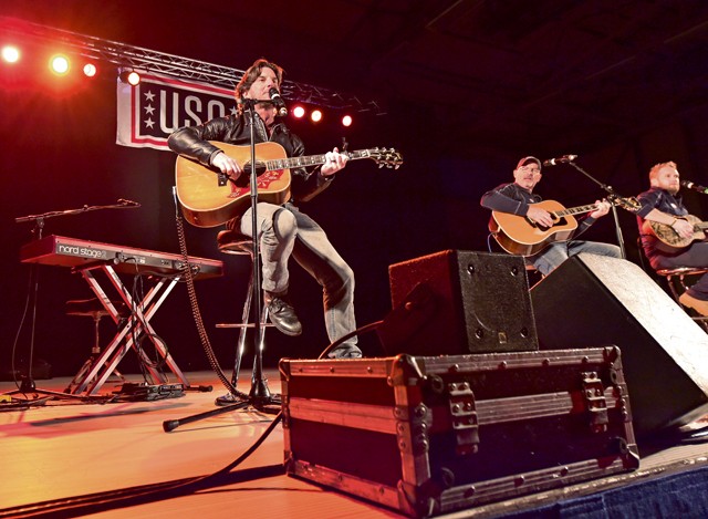 Photo by Staff Sgt. Leslie Keopka Singer and songwriter Brett James, along with Billy Montana and Kyle Jacobs, perform for the audience during the 2015 USO Holiday Troop Tour Dec. 9 on Ramstein. The entertainers gave away signed posters, movies and other items to thank the service members and their families for their services and sacrifices.