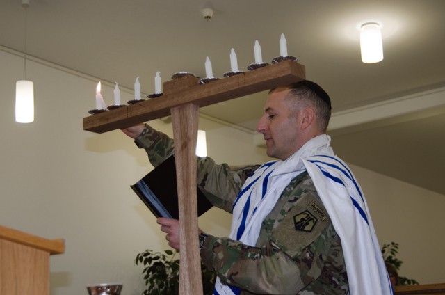 Chaplain (Maj.) Jonathan Zagdanski, 7th Mission Support Command, lights a Menorah to officially begin the celebration of Hanukkah Dec. 6 on Ramstein. The Festival of Lights historically goes back to 168 B.C. to the time of Judas Maccabeaus, who ordered an 80-day celebration following the rededication to the Temple in Jerusalem. Hanukkah runs through Sunday.