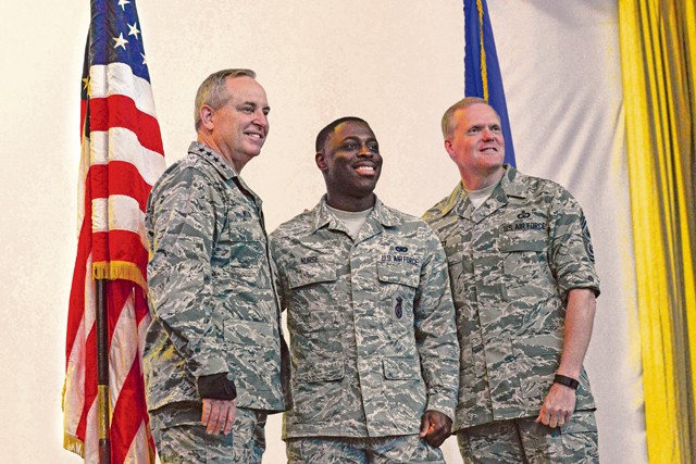 Courtesy photo Air Force Chief of Staff Gen. Mark A. Welsh III and Chief Master Sgt. of the Air Force James A. Cody pose for a photo with Senior Airman Wilon Nurse, 496th Air Base Squadron security forces flight member, after an all-call Dec. 8 on Morón Air Base, Spain. Welsh and Cody visited Morón to engage with Airmen of the squadron. During the visit, they thanked Airmen for their dedication to the mission and personal sacrifices. The leaders also made time to discuss and answer questions about recent changes to performance reporting systems and how they will affect future promotions.