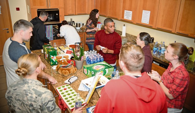 Members of the 450th Intelligence Squadron cook meals for the Landstuhl Fisher House Dec. 4 at Landstuhl Regional Medical Center. Volunteers scattered throughout the KMC to give their time to the annual Special Olympics, Landstuhl Fisher House, Junior ROTC and military post offices.