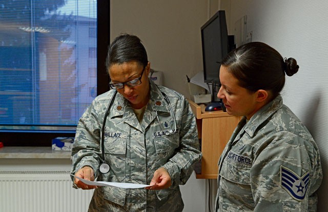 Staff Sgt. Megan Cotter, 86th Medical Operations Squadron NCO in charge of ambulance services, tells Maj. Courtney Wallace, Family Health Clinic clinical nurse, about the symptoms of a patient being seen at the Cold and Allergy Clinic Nov. 4 on Ramstein. The clinic was opened to help relieve the increased volume of patients brought to the Family Health Clinic suffering from symptoms associated with the winter and spring seasons.