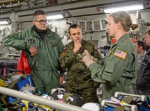 Polish air force 2nd Lts. Krzysztof Romek (left) and Andrzej Nartonowicz (center), aeromedical evacuation doctors, listen to Staff Sgt. Jesse Visser, 10th Expeditionary Aeromedical Evacuation Flight duty controller, explain the 10th EAEF mission Dec. 2 on Ramstein. Romek and Nartonowicz are members of the only Polish aeromedical evacuation team and familiarized themselves with practices used by U.S. Airmen.