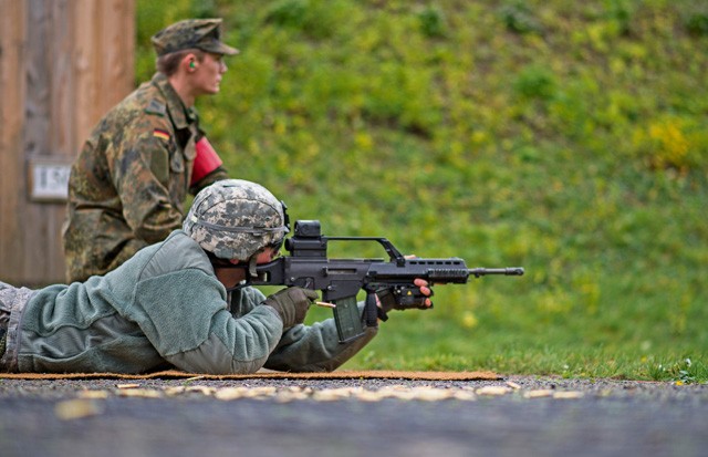 German army Pfc. Dominik Lagershausen, Airborne Infantry Regiment 26, 4th Company Airborne Troop, watches as Senior Airman Jonathan Ebner, 86th Security Forces Squadron unit fitness program manager, fires a G36 assault rifle Nov. 18 in Zweibruecken, Germany. More than 20 members of the 86th SFS shot German weapons to earn the “Bundeswehr,” German army, marksmanship badge and build partnership between the two nations.