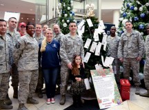Caylee Lewis poses with her father, Master Sgt. Allen Lewis, 450th Intelligence Squadron first sergeant and Angel Tree 2015 chair, and other members of the Kaiserslautern Military Community First Sergeant Council during the Angel Tree 2015 kickoff Dec. 7 on Ramstein. Angel Tree is an outreach program designed to provide assistance to Airmen and their families throughout the KMC.