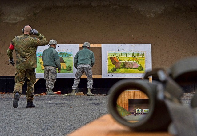 Members of the 86th Security Forces Squadron adjust targets in preparation for the next round of shooting Nov. 18 in Zweibruecken, Germany. Members of the 86th SFS shot the P8 pistol, G36 assault rifle and MG3 machine gun to earn the “Bundeswehr,” German army, marksmanship badge for weapons proficiency.