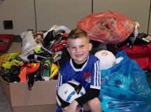 Courtesy photo
Brayden Tester, son of Chief Master Sgt. David Tester, U.S. Air Forces in Europe operations superintendent, poses in front of soccer equipment on Ramstein. Brayden gathered support from around the KMC to collect soccer equipment for Ethiopian children that his father told him “couldn’t afford shoes to play in or soccer balls to play with.”