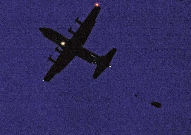 Airmen and Soldiers jump out of a Ramstein C-130J Super Hercules during a nighttime training scenario Dec. 18 at Alzey Drop Zone, Germany. As the paratroopers descended, they were greeted by the 435th Contingency Response Support Squadron independent duty medical technicians. The IDMTs operate with the 435th Contingency Response Group forces and were on scene in case of any medical emergencies.