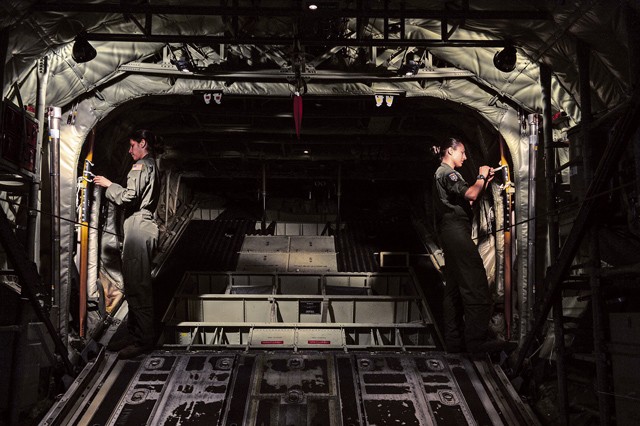 Photo by Senior Airman Nicole Sikorski U.S. Air Force Senior Airmen Giselle Toro and Tristan Geray, 37th Airlift Squadron loadmasters, prepare for a U.S. and Bulgarian air force formation flight over Plovdiv, Bulgaria, July 14, 2015. Loadmasters are responsible for the proper loading of cargo onto aircraft as well as ensuring passengers are both safe and comfortable during travel. In addition to securing cargo, Toro and Geray were both responsible for the safe departure of paratroopers from the aircraft during the flight.