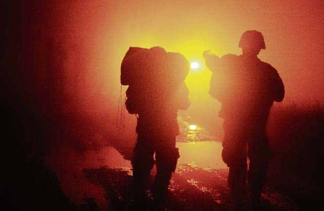 Two Soldiers walk towards an ambulance after jumping from a C-130J Super Hercules Dec. 18 at Alzey Drop Zone, Germany. The two were part of nighttime operations designed to improve not only the Army paratroopers, but also the 435th Air Ground Operations Wing capabilities.
