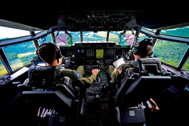Photo by Senior Airman Nicole Sikorski  Capts. Sean McKee (right) and Jonathan Recor, C-130J Super Hercules pilots assigned to the 37th Airlift Squadron, fly a C-130J during an orientation flight for German local nationals June 29, 2015, on Ramstein. McKee and Recor flew more than 20 German locals 500 feet off the ground, performing maneuvers and giving them a glimpse of the U.S. Air Force's side of the mission at Ramstein.