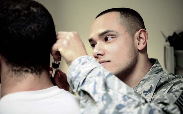 Tech. Sgt. Jose Obregon, 435th Contingency Response Support Squadron independent duty medical technician, examines a “patient” during a demonstration of IDMT duties Dec. 18 on Ramstein. IDMTs from the 435th Air Ground Operations Wing are not only required to know and understand tasks from the technician, nurse and doctor specializations, but must also be qualified to jump alongside paratroopers establishing, building and maintaining an airfield.