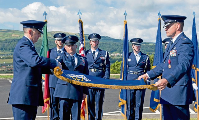 Photo by Master Sgt. Bradley C. Church Lt. Gen. Timothy Ray, commander of the 3rd Air Force and 17th Expeditionary Air Force, and Col. Martin Rothrock, commander of the 65th Air Base Wing, furl and encase the 65th Air Base Wing flag during a redesignation ceremony August 14, 2015, on Lajes Field, Azores, Portugal. With this redesignation ceremony, the 65th Air Base Group is now aligned under the 86th Airlift Wing and remains positioned to provide agile combat support and services to aircraft and aircrews.