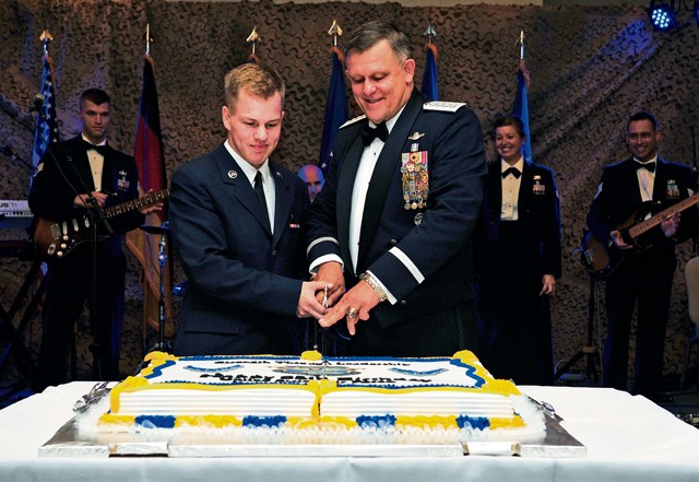 Photo by Airman 1st Class Larissa Greatwood Airman Ryan Darish, 86th Medical Support Squadron uniform business office technician, and Gen. Frank Gorenc, U.S. Air Forces in Europe and Air Forces Africa commander, cut a cake during the Air Force Ball Sept. 12, 2015, on Ramstein Air Base. The cake-cutting ceremony is an Air Force tradition in which the lowest and highest ranking Airmen in the room cut the cake together.