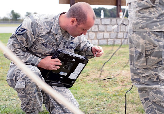 Photo by Staff Sgt. Armando Schwier-Morales Tech. Sgt. Jacob Peck, 7th Weather Squadron battlefield weather forecaster, secures a computer after a demonstration on operating with limited data in the field and using equipment to improve weather forecasting Sept. 16, 2015, at Grafenwoehr Training Area, Germany. The instructors of the 7th WS used a variety of tools including briefing and hands-on lessons to develop 30 battlefield weather airmen during the annual Cadre Focus training exercise. The  7th WS revamped Cadre Focus to concentrate on basic field training skills and forecasting in Eastern Europe. The squadron is the only one embedded alongside Army units providing weather intelligence throughout the European and African areas of operation.