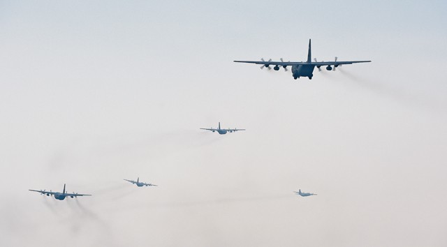 Photo by Senior Airman Damon Kasberg  U.S. and Polish C-130s fly in formation prior to participating in a friendly airlift competition during Aviation Detachment 16-1, Oct. 29, 2015, on Powidz Air Base, Poland. A total of seven aircraft flew together, marking the largest C-130 formation at Powdiz.