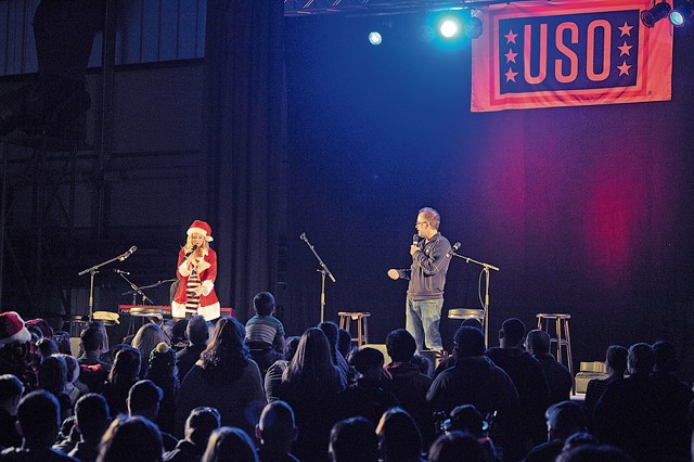 Photo by Staff Sgt. Timothy Moore Actors Elizabeth Banks and David Wain talk with the crowd during the 2015 USO Holiday Troop Tour Dec. 9, 2015, on Ramstein. Ramstein was the last stop of the 15th annual tour.