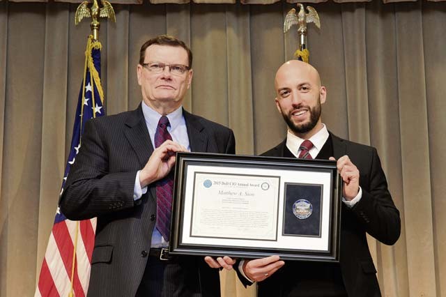 Photo by Eboni Everson-Myart Terry Halvorsen, Department of Defense chief information officer (left), poses with Matthew Sion, 1st Air and Space Communications Operations Squadron European Partner Integration Enterprise system support chief, at the 2015 Department of Defense Chief Information Officer Award for Cyber and IT Excellence ceremony Dec. 1 at the Pentagon in Washington, D.C. Sion won first place in the individual category for his efforts in support of current operations in and around Europe.