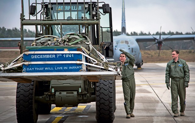 Photo by Senior Airman Damon Kasberg Airman 1st Class Dylan Arnt, 37th Airlift Squadron loadmaster, directs an Airman as she drives a forklift with cargo into a C-130J Super Hercules Jan. 20, 2015, on Ramstein. Cargo loaded into a C-130J must be carefully placed on the ramp to ensure no damage occurs to it or the aircraft. 