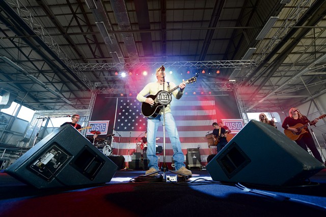 Photo by Airman 1st Class Tryphena Mayhugh Country music singer Trace Adkins performs for members of the KMC during a USO concert  April 20, 2015, on Ramstein. Adkins has participated in 10 USO tours and has performed for troops in seven countries.