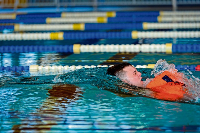 Photo by Senior Airman Nicole Sikorski Senior Airman Robert Newman, 86th Aeromedical Evacuation Squadron mission management technician, performs a wind drag during a survival, evasion, resistance and escape water survival course April 13, 2015, on Ramstein. Drags are practiced to simulate a parachute opening after evacuating an aircraft.