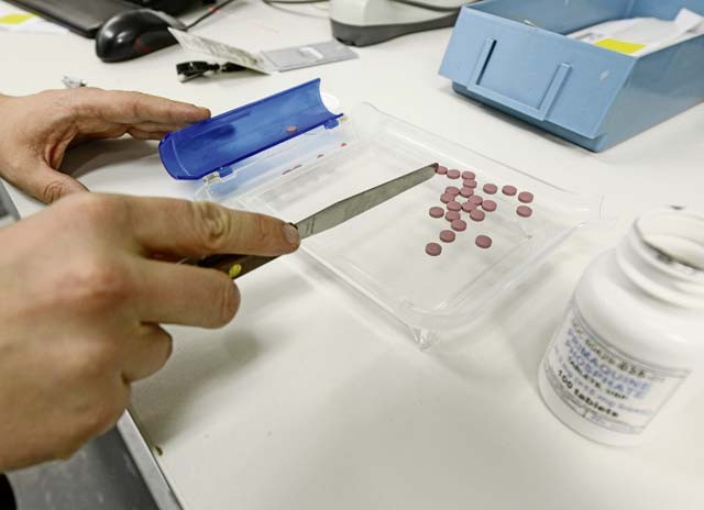 A pharmacy technician counts out pills to fill a prescription for a patient Dec. 15 at the Ramstein pharmacy. The pharmacy uses a nine-rights policy which helps to verify the patient’s information, the dose and the amount is accurate to ensure patient safety.