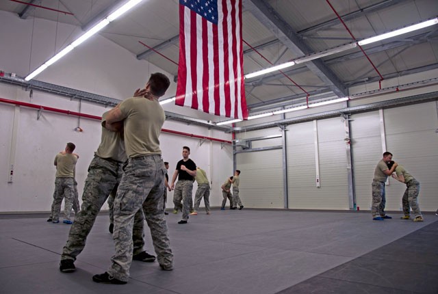Security forces Airmen practice self-defense maneuvers during a security forces combative course Jan. 14 on Ramstein. Approximately 21 students attended the seven-day course to improve weapon retention and self-defense skills that can be used to handle hostile situations with the most peaceful means possible.