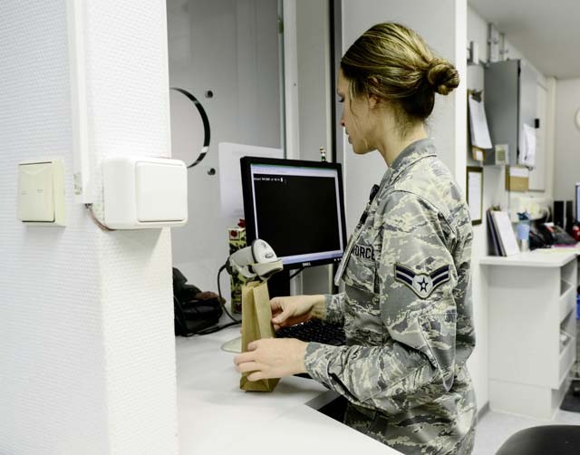 Airman 1st Class Maddison Hawkins prepares medication for a customer Dec. 15 at the Ramstein pharmacy window. Hawkins is responsible for greeting patients, preparing refills and ensuring the patient is informed on their prescriptions.